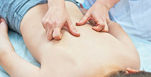 hands massaging somebody's back skin